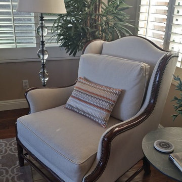 Wood trim wing chair with espresso nailhead detail