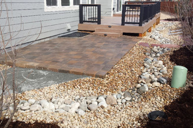 This is an example of a small rustic drought-tolerant and full sun backyard concrete paver landscaping in Denver for summer.