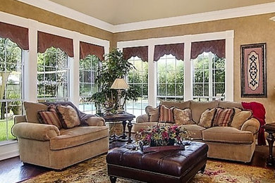Large elegant open concept medium tone wood floor living room photo in Houston with beige walls, a standard fireplace and a tile fireplace