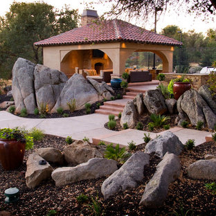 Mediterranean backyard garden in Sacramento with with rock feature.