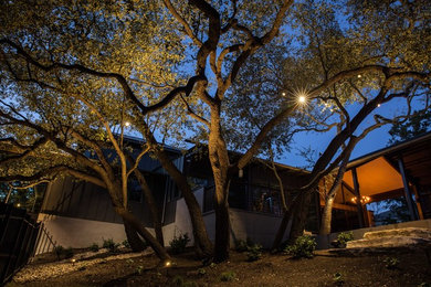 Inspiration for a large modern full sun front yard stone driveway in Austin.