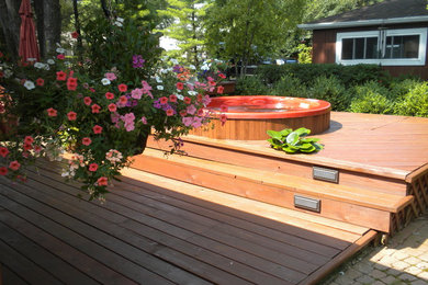 Design ideas for a small modern backyard deck in Chicago with a water feature and no cover.