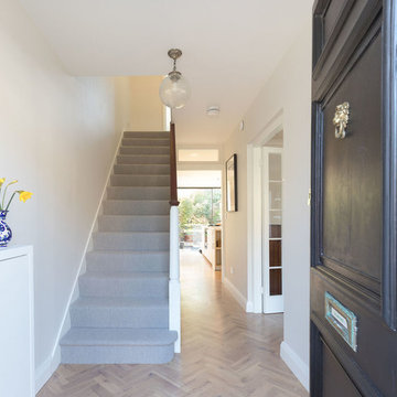 Bright open plan ground floor with grey carpeted staircase