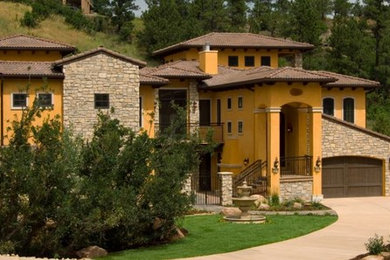 Example of a tuscan home design design in Denver
