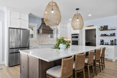Inspiration for a large transitional galley light wood floor and beige floor eat-in kitchen remodel in DC Metro with quartzite countertops, beige backsplash, ceramic backsplash, stainless steel appliances, an island, white countertops, an undermount sink, shaker cabinets and white cabinets