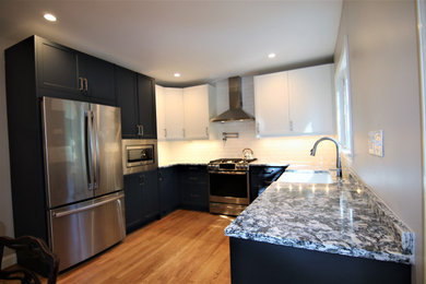 Inspiration for a kitchen remodel in DC Metro with a farmhouse sink, shaker cabinets, blue cabinets, quartz countertops, white backsplash, ceramic backsplash, stainless steel appliances and multicolored countertops