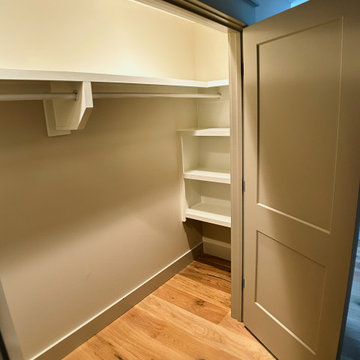 Elegant Hall Closet Organization: White Built-Ins, Open Cubbies, and Hanging St