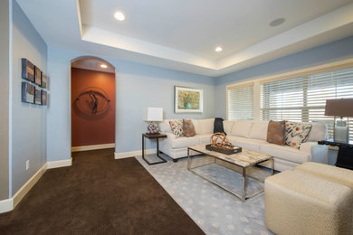 This is an example of a mid-sized transitional open concept family room in Denver with blue walls, carpet, no fireplace and a freestanding tv.
