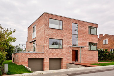 Inspiration for a modern two-storey brick house exterior in Aarhus with a flat roof.