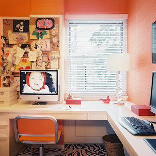 Inspiration for a medium sized modern study in New York with orange walls, carpet, no fireplace and a built-in desk.