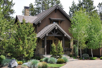 Large mountain style brown gable roof photo in Denver