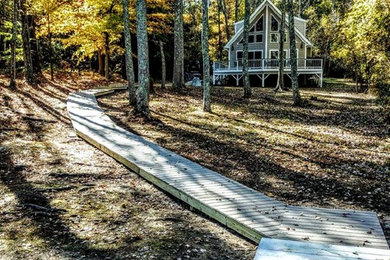 Inspiration for a huge rustic partial sun backyard walkway in Other with decking for fall.
