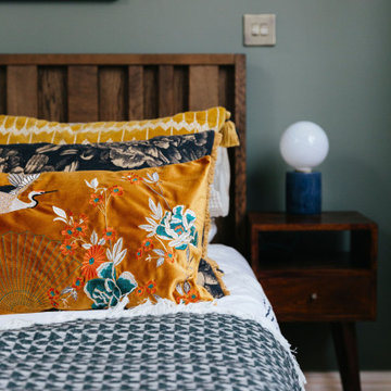 Stunning, modern and vintage styled bedroom with green feature wall