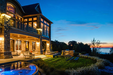 Inspiration for a huge timeless brown three-story stone exterior home remodel in Other