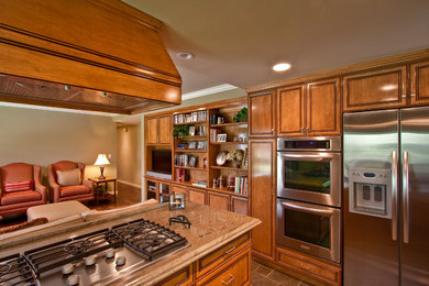 Inspiration for a mid-sized contemporary u-shaped ceramic tile open concept kitchen remodel in Los Angeles with raised-panel cabinets, medium tone wood cabinets, granite countertops, stainless steel appliances and an island