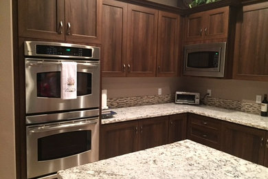 Inspiration for a mid-sized transitional l-shaped limestone floor and beige floor open concept kitchen remodel in Other with an undermount sink, shaker cabinets, dark wood cabinets, granite countertops, multicolored backsplash, matchstick tile backsplash, stainless steel appliances and an island