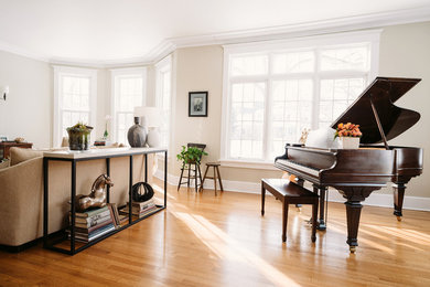Example of a large transitional formal light wood floor living room design in Other