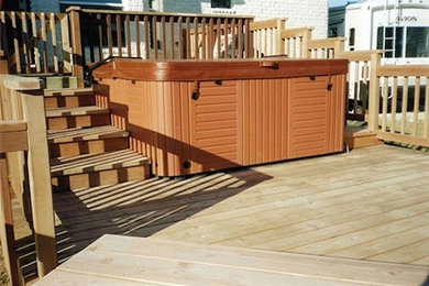 Example of a mid-sized classic backyard deck design in Austin with a pergola