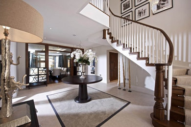 Design ideas for an expansive contemporary hallway in Sussex with beige walls and carpet.