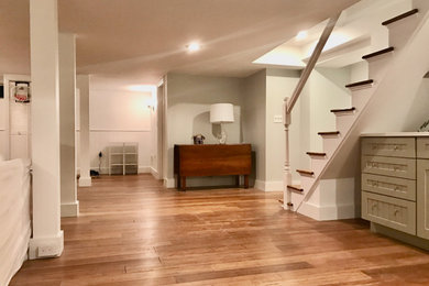 Example of a mid-sized trendy underground wainscoting basement design in Boston with a bar