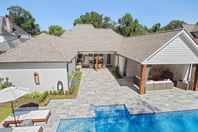 Pool house - mid-sized contemporary backyard stone and rectangular natural pool house idea in Other