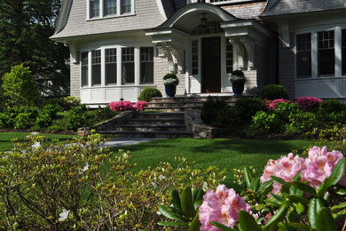 Photo of a mid-sized transitional front yard stone landscaping in Boston.