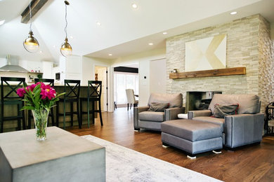 Living room - large transitional open concept medium tone wood floor and brown floor living room idea in Chicago with gray walls, a two-sided fireplace and a stone fireplace