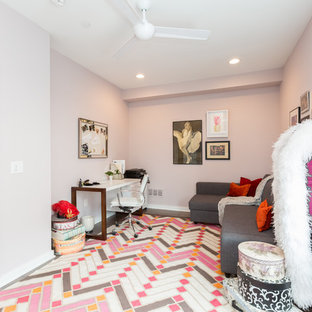 Photo of a medium sized modern study in Philadelphia with pink walls, medium hardwood flooring, a freestanding desk and pink floors.