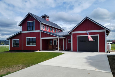 Mid-sized farmhouse red two-story concrete fiberboard and board and batten exterior home photo in Seattle with a metal roof and a gray roof