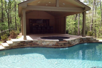 Inspiration for a mid-sized contemporary backyard stone and custom-shaped lap hot tub remodel in Atlanta