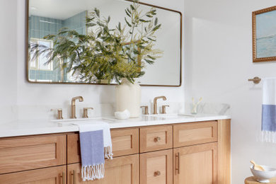 Example of a mid-sized trendy master blue tile and ceramic tile porcelain tile, gray floor and double-sink bathroom design in San Francisco with light wood cabinets, white walls, an undermount sink, quartz countertops, white countertops and a niche