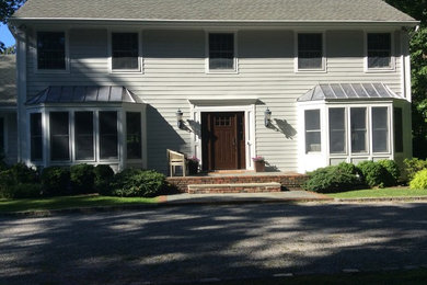 Inspiration for a timeless beige two-story concrete fiberboard gable roof remodel in New York