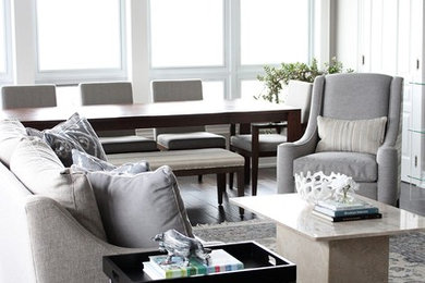 Living room - mid-sized traditional open concept medium tone wood floor and brown floor living room idea in Toronto with gray walls, a standard fireplace and a plaster fireplace