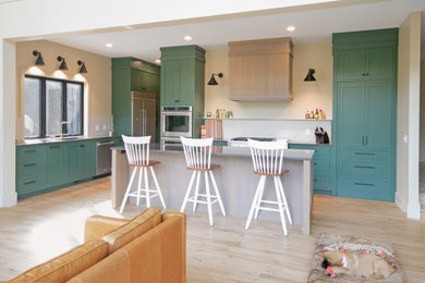 Eat-in kitchen - scandinavian light wood floor eat-in kitchen idea in Grand Rapids with an undermount sink, shaker cabinets, green cabinets, quartz countertops, white backsplash, porcelain backsplash, stainless steel appliances, an island and gray countertops