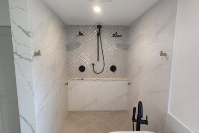Inspiration for a mid-sized contemporary master white tile and porcelain tile ceramic tile, gray floor, double-sink and wainscoting bathroom remodel in Ottawa with flat-panel cabinets, medium tone wood cabinets, a two-piece toilet, multicolored walls, an undermount sink, granite countertops, white countertops and a freestanding vanity