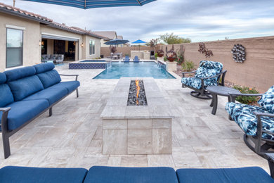 This is an example of a large contemporary back rectangular natural swimming pool in Phoenix with with pool landscaping and concrete paving.