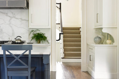 Medium tone wood floor eat-in kitchen photo in Cincinnati with flat-panel cabinets, white cabinets, marble countertops and an island