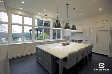 Eat-in kitchen - large modern l-shaped gray floor eat-in kitchen idea in Portland with an undermount sink, shaker cabinets, white cabinets, quartz countertops, white backsplash, subway tile backsplash, white appliances, an island and white countertops