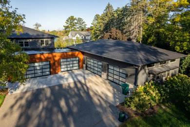 Huge minimalist attached four-car garage workshop photo in Minneapolis