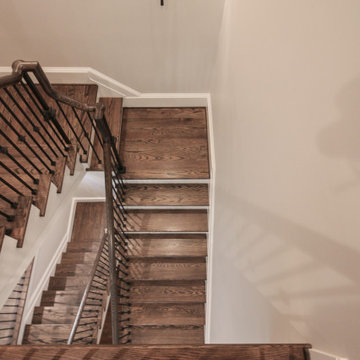 Project #86 | Sweeping Curved Staircase with Iron Balusters