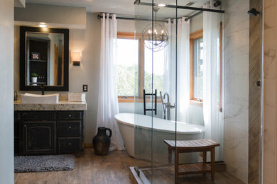 Bathroom - large contemporary master brown tile, gray tile and porcelain tile porcelain tile and brown floor bathroom idea in Other with raised-panel cabinets, distressed cabinets, brown walls, a drop-in sink and a hinged shower door