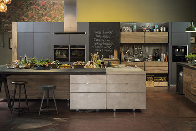 Inspiration for a large country kitchen in Other with black appliances and with island.