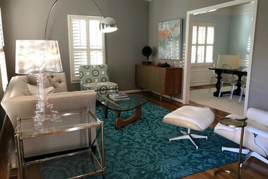 Inspiration for a transitional formal medium tone wood floor living room remodel in Other with gray walls, no fireplace and no tv