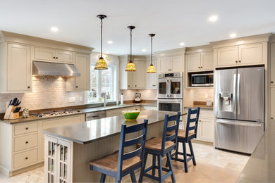 Inspiration for a mid-sized timeless l-shaped eat-in kitchen remodel in Boston with recessed-panel cabinets, white cabinets, quartz countertops, stainless steel appliances and an island