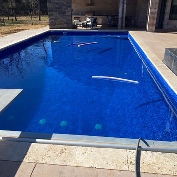 Polymer vinyl liner pool w/concrete spillover spa & automatic pool cover