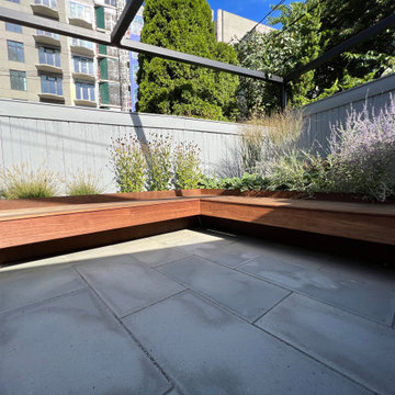 Paved patio with metal grating garden