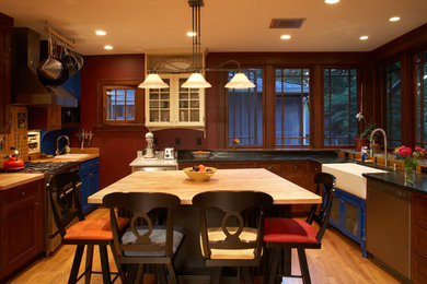 Inspiration for a transitional u-shaped eat-in kitchen in Other with dark wood cabinets.