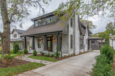 Large transitional brown two-story brick exterior home idea in Nashville with a shingle roof