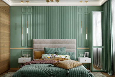 На фото: спальня в современном стиле с зелеными стенами и полом из ламината с