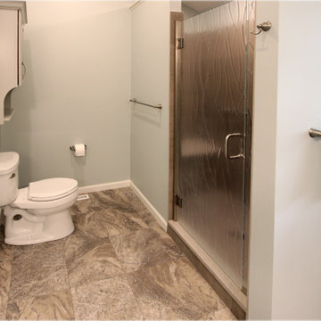 Warm Gray Vanity with Maple Truffle Accent Linen Cabinet and Tiled Shower
